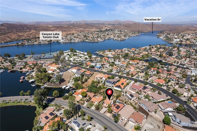 drone / aerial view with a water and mountain view