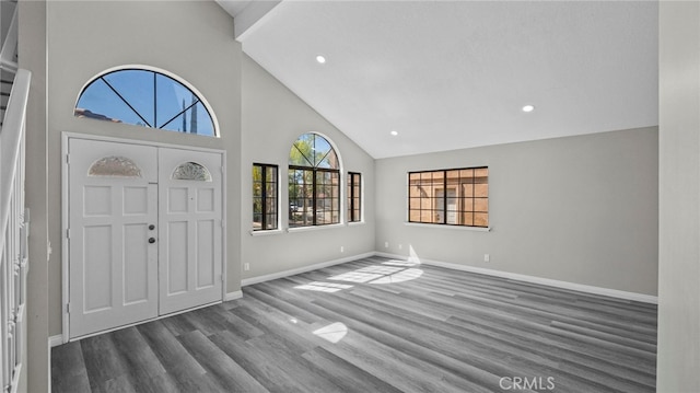 entrance foyer with hardwood / wood-style floors and high vaulted ceiling