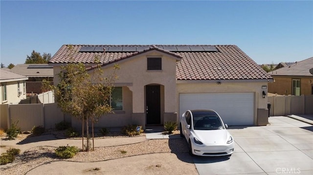 mediterranean / spanish home with solar panels and a garage