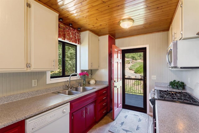 kitchen with wood ceiling, white cabinetry, appliances with stainless steel finishes, and sink