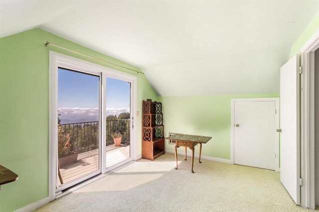 misc room with lofted ceiling and light colored carpet