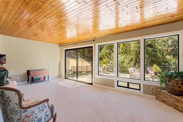 sitting room with wood ceiling and carpet flooring