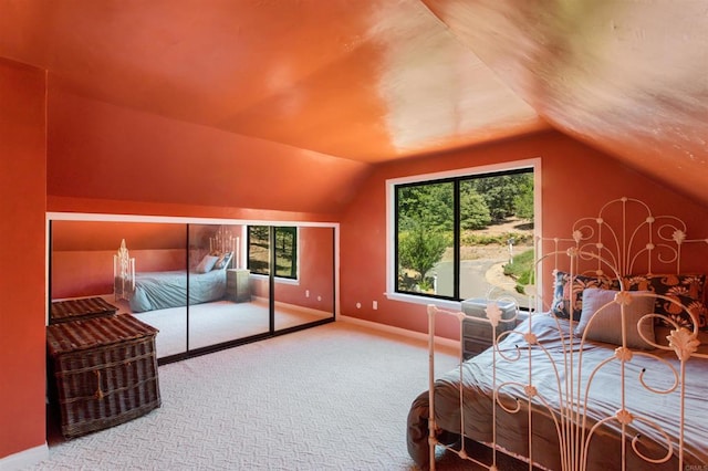 bedroom featuring multiple windows, lofted ceiling, and carpet floors