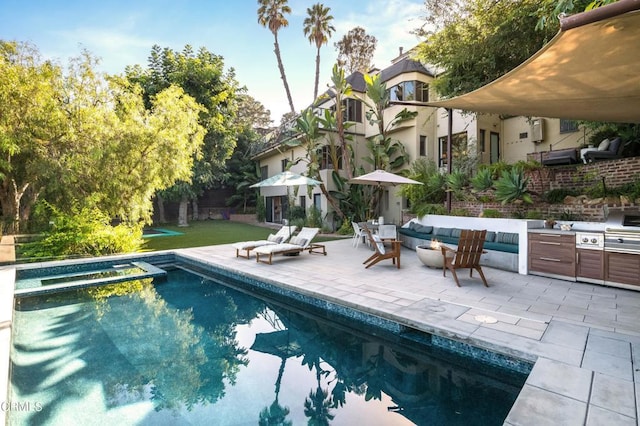 view of swimming pool featuring outdoor lounge area, exterior kitchen, a patio area, an in ground hot tub, and area for grilling