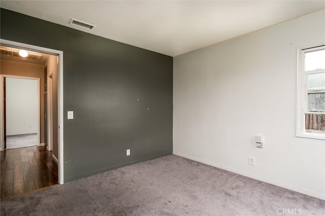 spare room featuring dark wood-type flooring