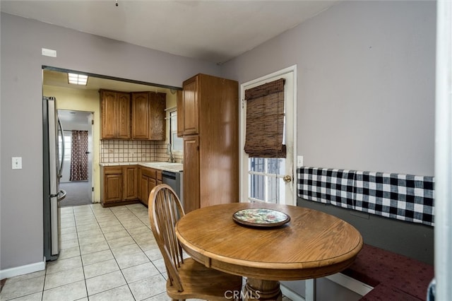 dining area with sink and light tile patterned floors