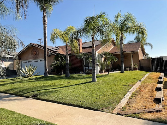 ranch-style home featuring a garage and a front lawn