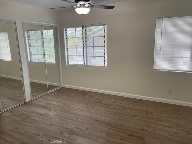 unfurnished bedroom featuring ceiling fan and dark hardwood / wood-style floors