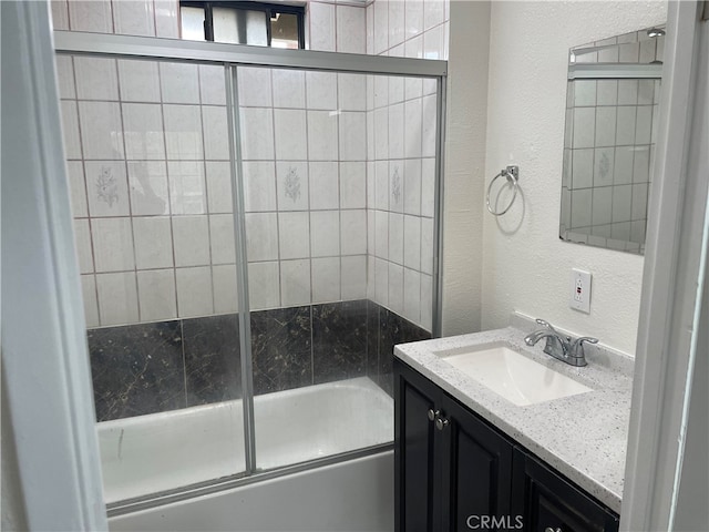 bathroom featuring vanity and enclosed tub / shower combo