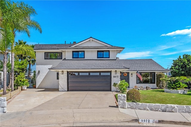 view of front of house featuring a front yard and a garage