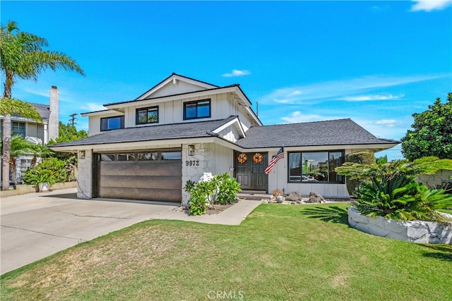 view of front of property featuring a front lawn and a garage