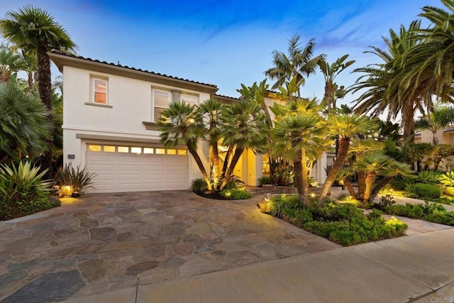 mediterranean / spanish-style home featuring a garage