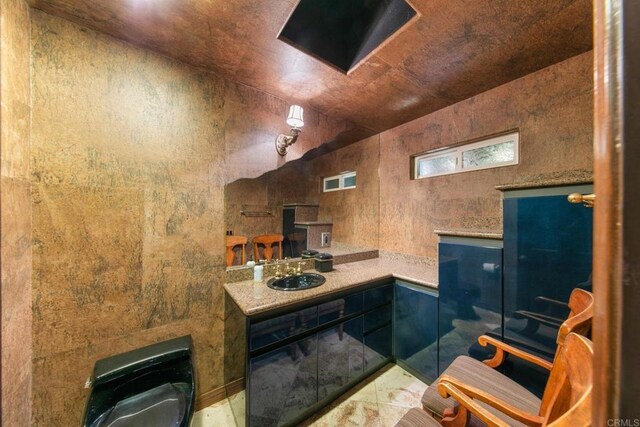 bathroom featuring wooden ceiling and sink