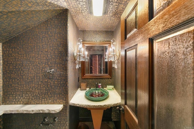 bathroom featuring brick ceiling and lofted ceiling