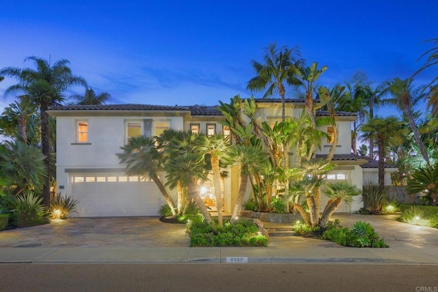 mediterranean / spanish-style home featuring a garage