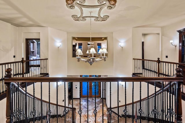 corridor with an inviting chandelier