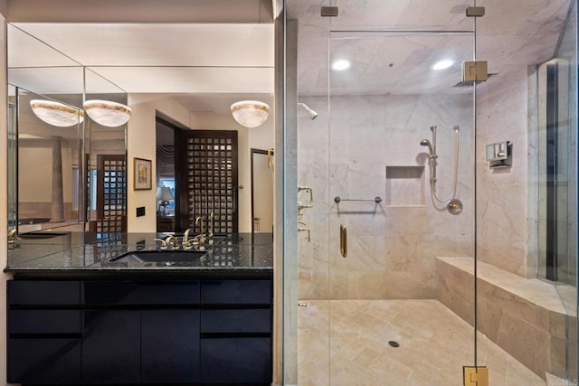 bathroom featuring walk in shower and vanity