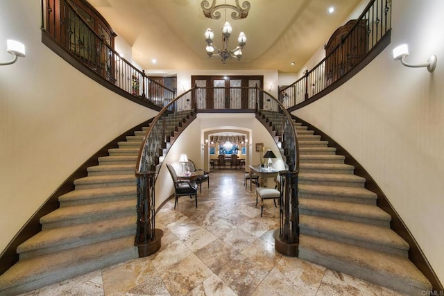 foyer entrance with a notable chandelier and a high ceiling