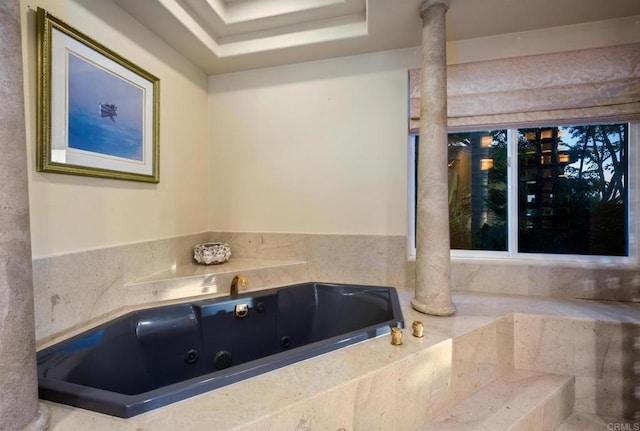 bathroom with a relaxing tiled tub