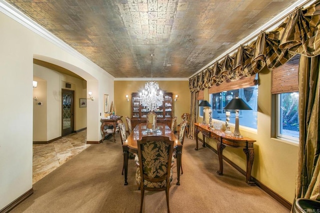 carpeted dining area featuring crown molding and an inviting chandelier