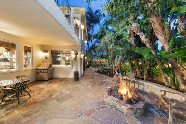 view of patio / terrace with an outdoor fire pit and a grill