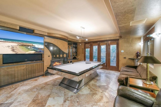 playroom featuring pool table, french doors, and a fireplace