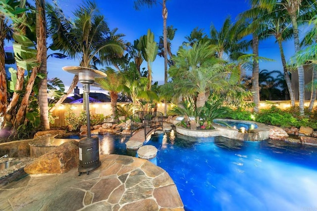 view of swimming pool with an in ground hot tub and a patio area