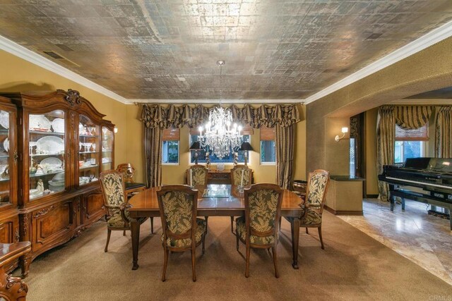 dining area featuring an inviting chandelier and crown molding