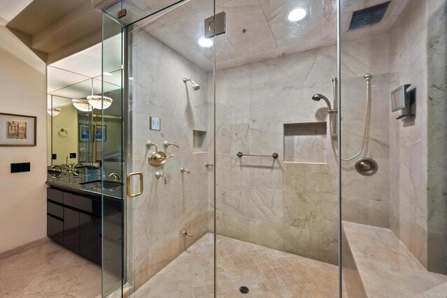 bathroom featuring vanity and a shower with door