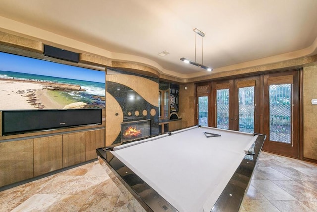 playroom with pool table, french doors, and a fireplace