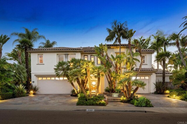 mediterranean / spanish-style home featuring a garage