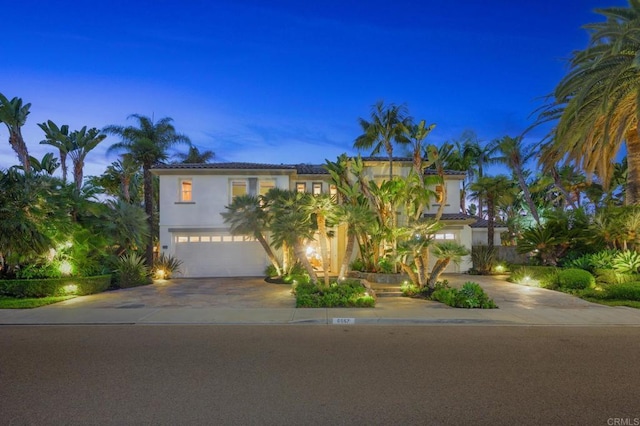 mediterranean / spanish-style house with a garage