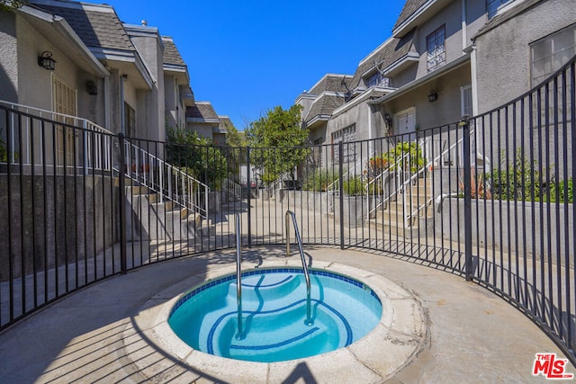 view of pool featuring a community hot tub