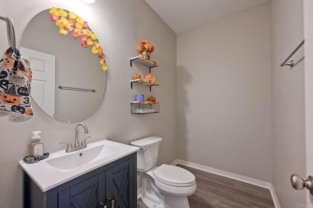 bathroom featuring hardwood / wood-style flooring, vanity, and toilet