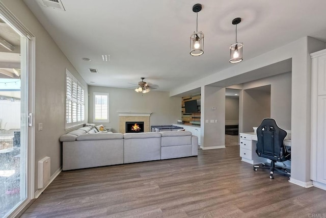 living room featuring hardwood / wood-style floors and ceiling fan