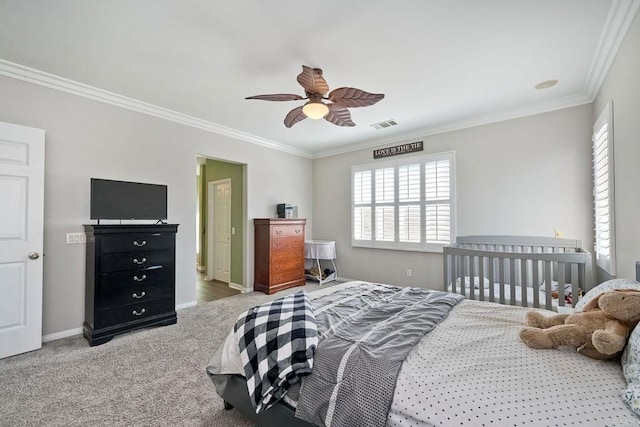 carpeted bedroom featuring ornamental molding and ceiling fan