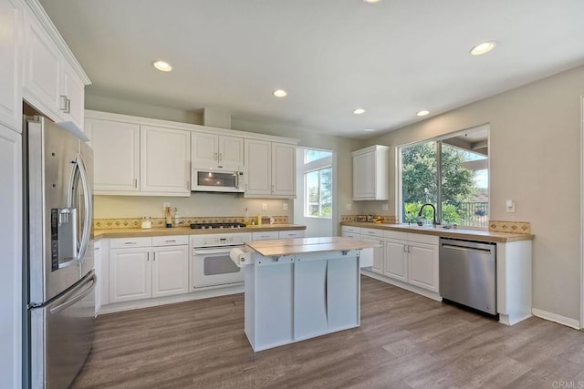 kitchen with appliances with stainless steel finishes, a center island, and white cabinets