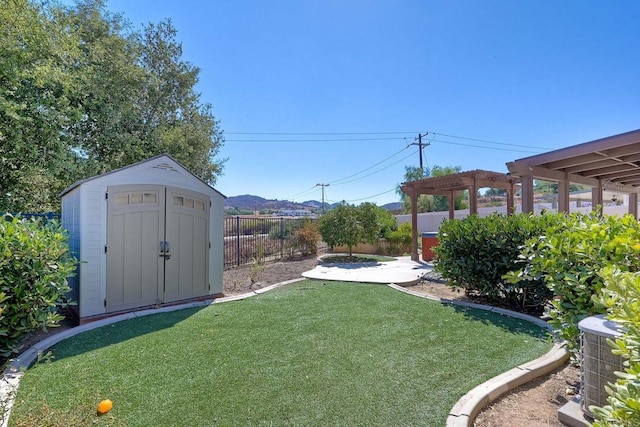 view of yard with a storage unit, central AC, a patio area, and a pergola