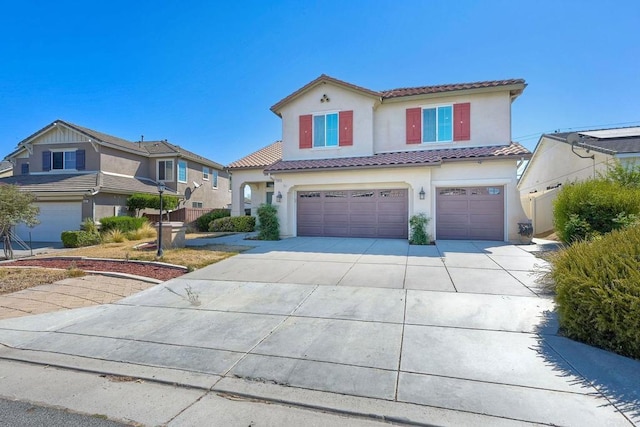 mediterranean / spanish-style house with a garage