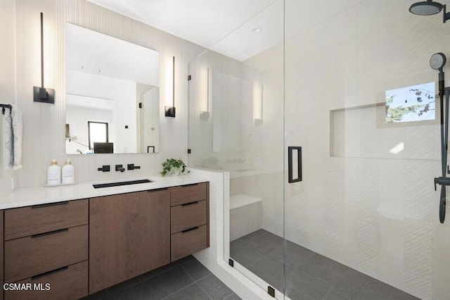 bathroom featuring decorative backsplash, vanity, tile patterned floors, and a shower with door