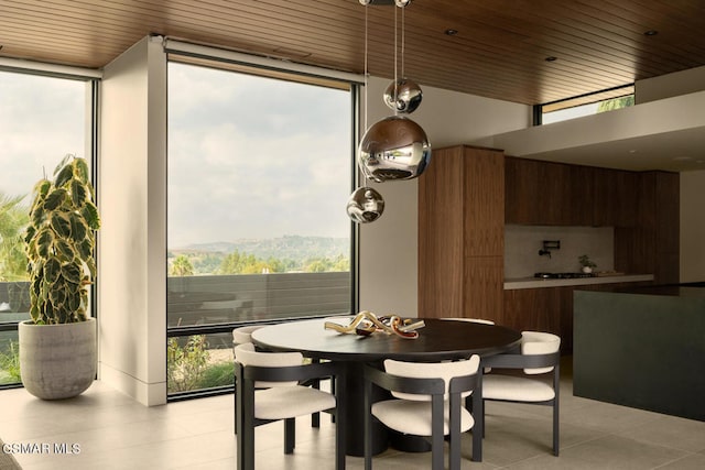 dining space featuring a healthy amount of sunlight and wood ceiling