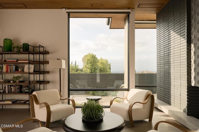 sitting room with wood ceiling and plenty of natural light