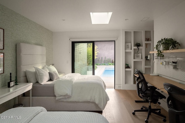 bedroom featuring hardwood / wood-style flooring and access to outside