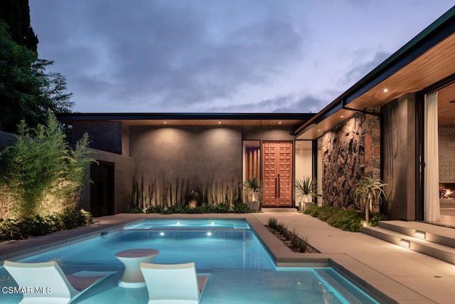 view of swimming pool with an in ground hot tub