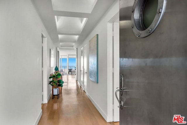 corridor with light hardwood / wood-style flooring