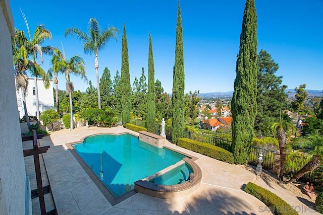 view of swimming pool with an in ground hot tub and a patio area