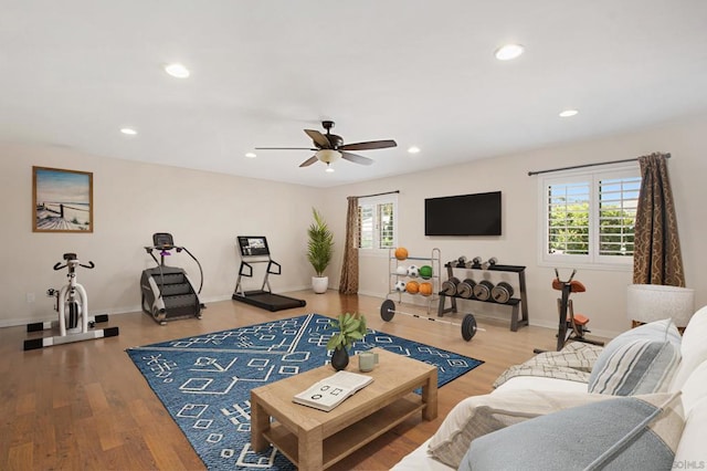 living room featuring ceiling fan, wood-type flooring, and plenty of natural light