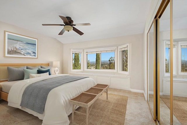 bedroom with light carpet, lofted ceiling, and ceiling fan