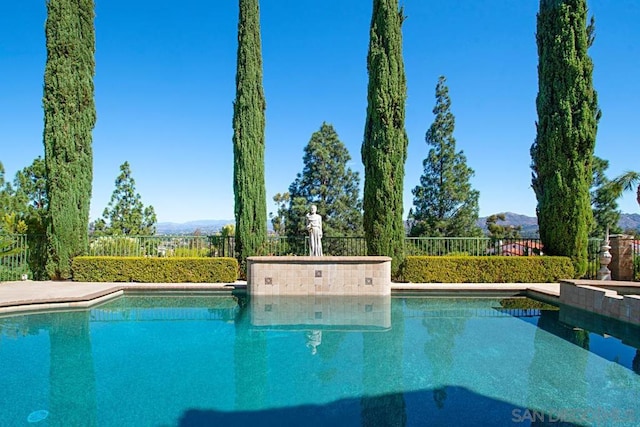 view of swimming pool featuring a mountain view