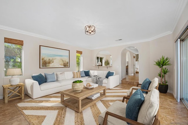 living room featuring ornamental molding and a healthy amount of sunlight